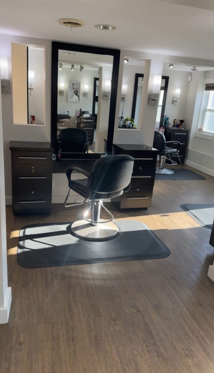 Modern hair salon with black styling chairs and mirrors at YOLOve beauty premium spa in Dartmouth, Nova Scotia